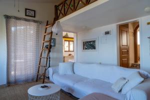 ein Wohnzimmer mit einer weißen Couch und einer Leiter in der Unterkunft Modern Villas with gardens and stunning views in Ligaria