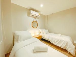 a hospital room with two beds and a fan at YAKTHAI POSHTEL in Bangkok