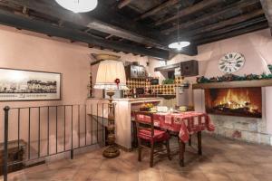 a dining room with a table and a fireplace at Casetta Di Carlo Magno in Sutri