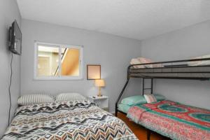 a bedroom with two bunk beds and a window at Pet Friendly near AF Academy in Colorado Springs