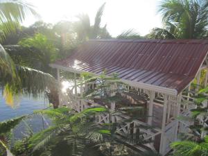 a gazebo on the beach with palm trees at Easy Inn Hotel in Belize City
