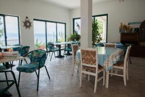 a dining room with a table and chairs and the ocean at Apartments Agava-Mirjana in Omiš