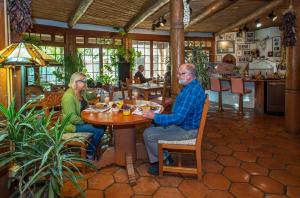 two people sitting at a table in a restaurant at Inn on La Loma Plaza in Taos