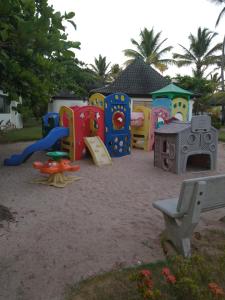 a playground with a bunch of play equipment in the sand at Beach Class Muro Alto Porto de Galinhas in Porto De Galinhas
