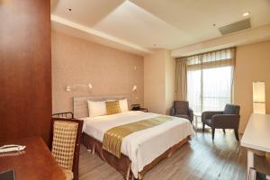 a hotel room with a bed and a table and chairs at 9 Hotel in Xindian