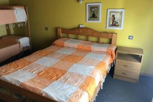 a bedroom with a bed and a nightstand next to it at Brisas de Mar in Monte Hermoso