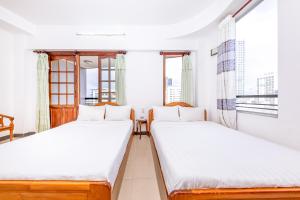 Giường trong phòng chung tại Minh Cat Hotel