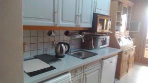 a kitchen with a sink and a microwave at St Gervais, Home With A View; 3 Beds, Pkg, Central in Saint-Gervais-les-Bains
