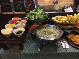 a buffet with bowls of different types of food at iuDia Hotel in Phra Nakhon Si Ayutthaya
