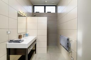 a white bathroom with a sink and a mirror at Dunalistair House at The Kinloch Club Golf Course in Kinloch +16 photos