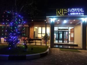 a lit up christmas tree in front of a hotel at NP Hotel in Buriram