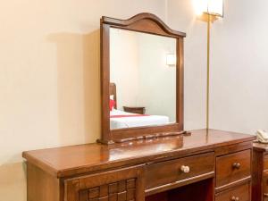 a wooden dresser with a mirror on top of it at Hotel Esperanza, Oaxaca Centro in Oaxaca City