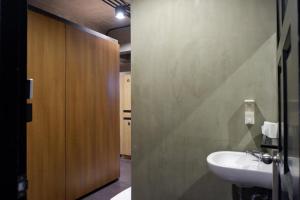 a bathroom with a sink and a mirror and a door at bangkok bed place in Bangkok +96 photos