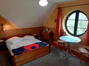 a bedroom with a bed and a round window at Dworek Sylwia in Wisła