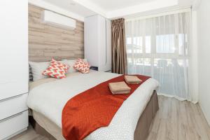 sypialnia z dużym łóżkiem i oknem w obiekcie Christmas Island Apartments we Flying Fish Cove