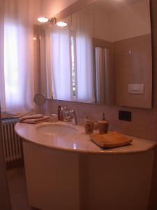 a bathroom with a sink and a large mirror at Villa Niccolò in Griante Cadenabbia