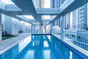 a swimming pool in a building with tall buildings at Frank Porter - Mon Reve in Dubai