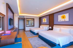 Giường trong phòng chung tại Vung Tau Riva Hotel