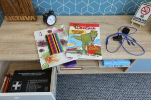 a table with books and other items on it at Delightful Apartment - FREE PARKING - NETFLIX in Kaunas