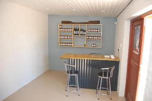 a bar in a room with two stools at Longacre Olive & Vineyard Estate in Langebaan