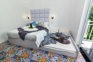 a bedroom with two beds and a rug at FRESIA by J&J ( Near Airport. 50 Mbps Wifi .Netflix ) in Mactan