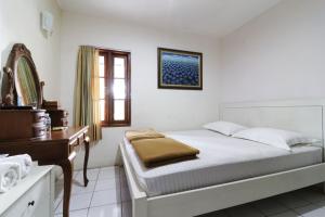 Postel nebo postele na pokoji v ubytování Jayagiri Guesthouse By Belgareti