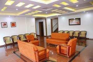 a waiting room with a row of chairs in a room at KRISHNA HOLIDAY VILLAGE in Trichūr