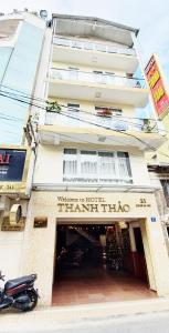 a moped parked in front of a apartment building at Thanh Thao Dalat Hotel in Da Lat