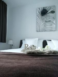 a bedroom with a bed with a black and white picture at Alpen-Appartements Zürcher in Kappl