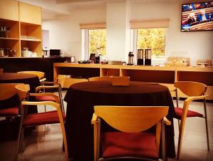 a restaurant with tables and chairs and a counter at Hotel Europa in Vila Pouca de Aguiar