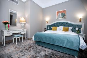 Postel nebo postele na pokoji v ubytování Grand Hotel Traian