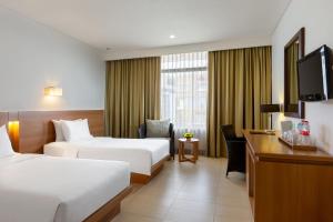 Postel nebo postele na pokoji v ubytování Hotel Santika Bandung