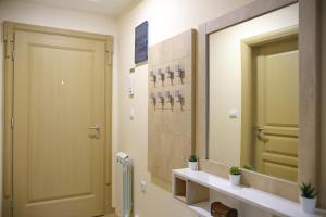 a bathroom with a door and a sink and a mirror at Apartman Vip Aleksa Zlatibor Centar in Zlatibor +56 photos