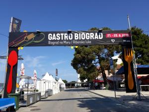 a sign for a seafood restaurant on a street at Apartments STAR with Pool in Biograd na Moru