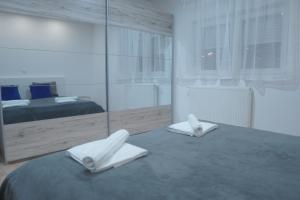 a bedroom with a bed and a large mirror at BLACK APARTMENT by ALEX RAFAEL in Zagreb