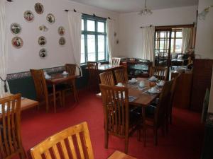 a dining room with a table and chairs and plates on the wall at Picton House B&B and Motel in Picton