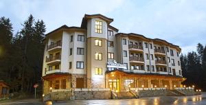 a large building with lights in front of it at HQ apartments Villa Park in Borovets