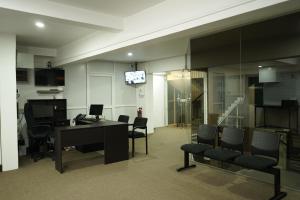 an office with a desk and chairs and a television at SkyCasa Holiday Apartments in Mount Lavinia