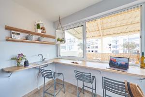 a kitchen with a counter and chairs and a window at toStay-Unique apartment hotel in Athens center! in Athens