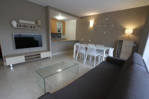 a living room with a couch and a table at For a Stay Aqquaria Deluxe in Salou