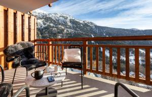 a balcony with a view of a snowy mountain at TERRESENS - Le Saphir in Vaujany