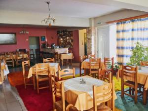 a restaurant with tables and chairs in a room at Ξενοδοχείο "Ηραία" in Iamatikes Piges