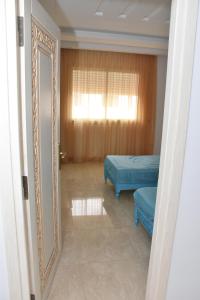 a room with two beds and a mirror at Arabesque Style - 2 appartements in Kelibia