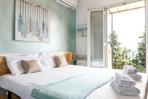a bedroom with a bed with towels on it at Villa Azur Cap d'Ail in Cap d'Ail