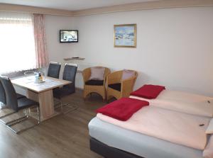 um quarto com uma cama, uma mesa e cadeiras em Birkenhof em Ehrwald