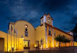 a building with a clock tower on top of it at Pousada Convento de Tavira in Tavira