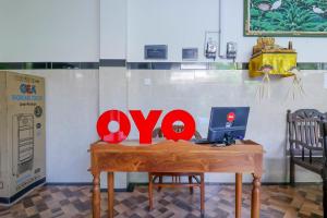 a desk with a laptop and a computer on it at OYO 2143 Leluhur Bali Apartment in Seminyak