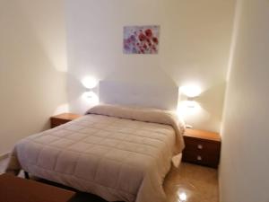 a bedroom with a bed with two night stands and two lamps at Come D'Incanto A Napoli in Naples