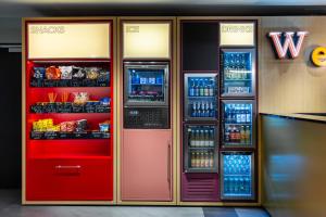 a vending machine with soda and drinks in it at AZIMUT Hotel Vienna in Vienna