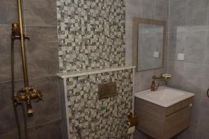 a bathroom with a sink and a mirror at Arabesque Style - 2 appartements in Kelibia